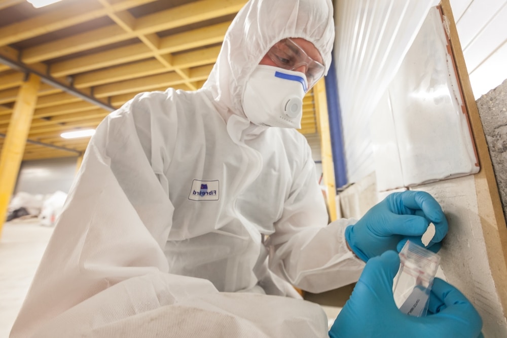 Asbestos Surveyor Taking A Sample